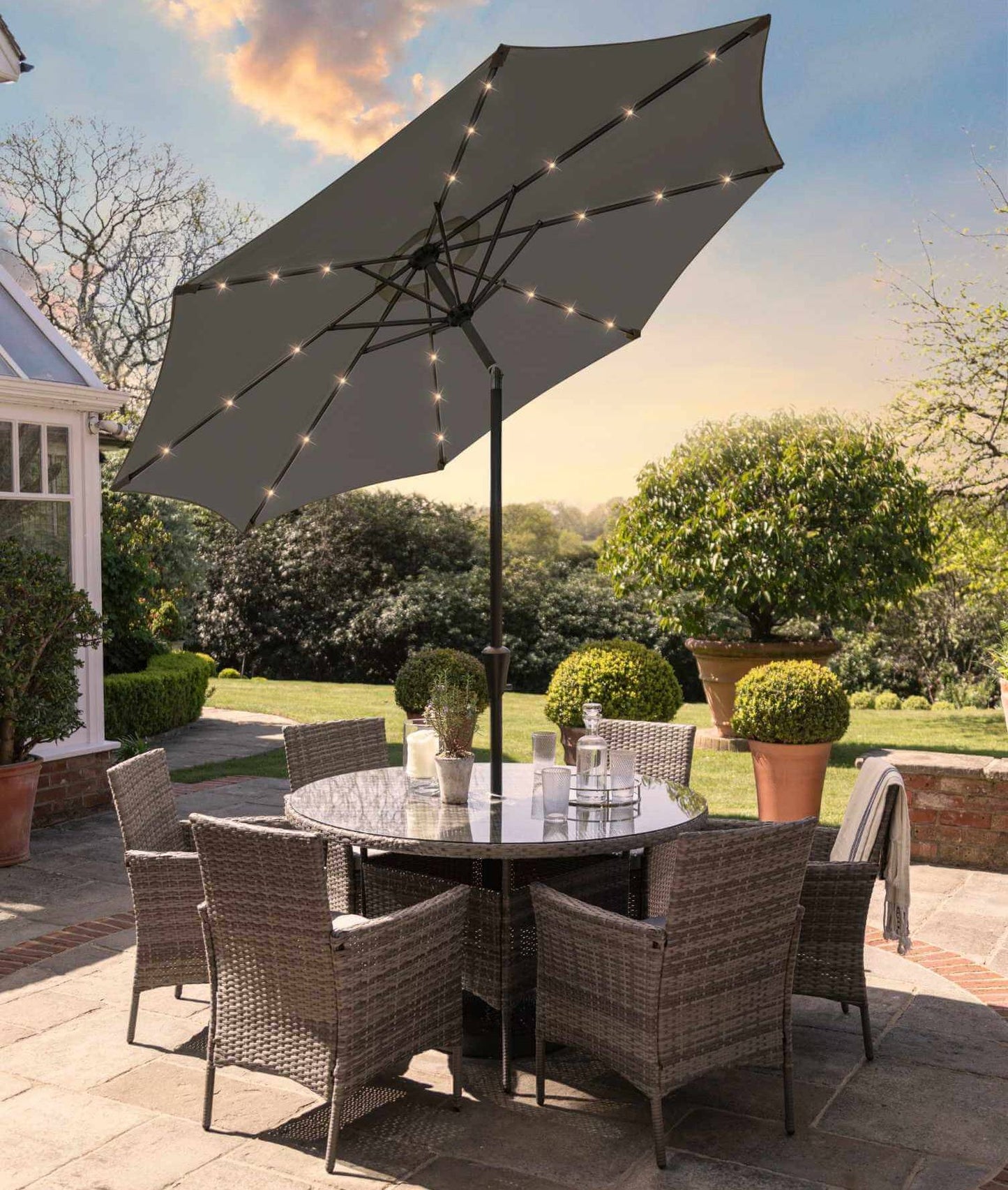 Kemble 6 Seater Rattan Round Dining Set with Grey LED Premium Parasol & Parasol Rain Cover - Grey