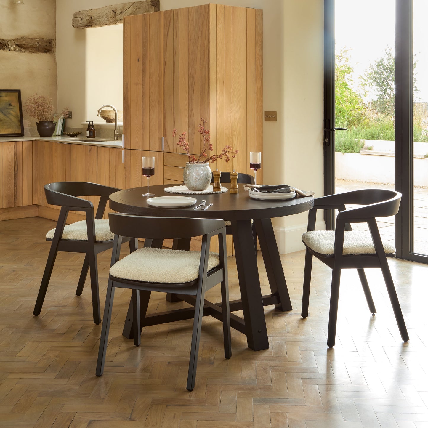Charlotte Black Oak Round Dining Table Set - 4 Seater - Ella Black Oak Carver Chairs - Off White Boucle - Laura James