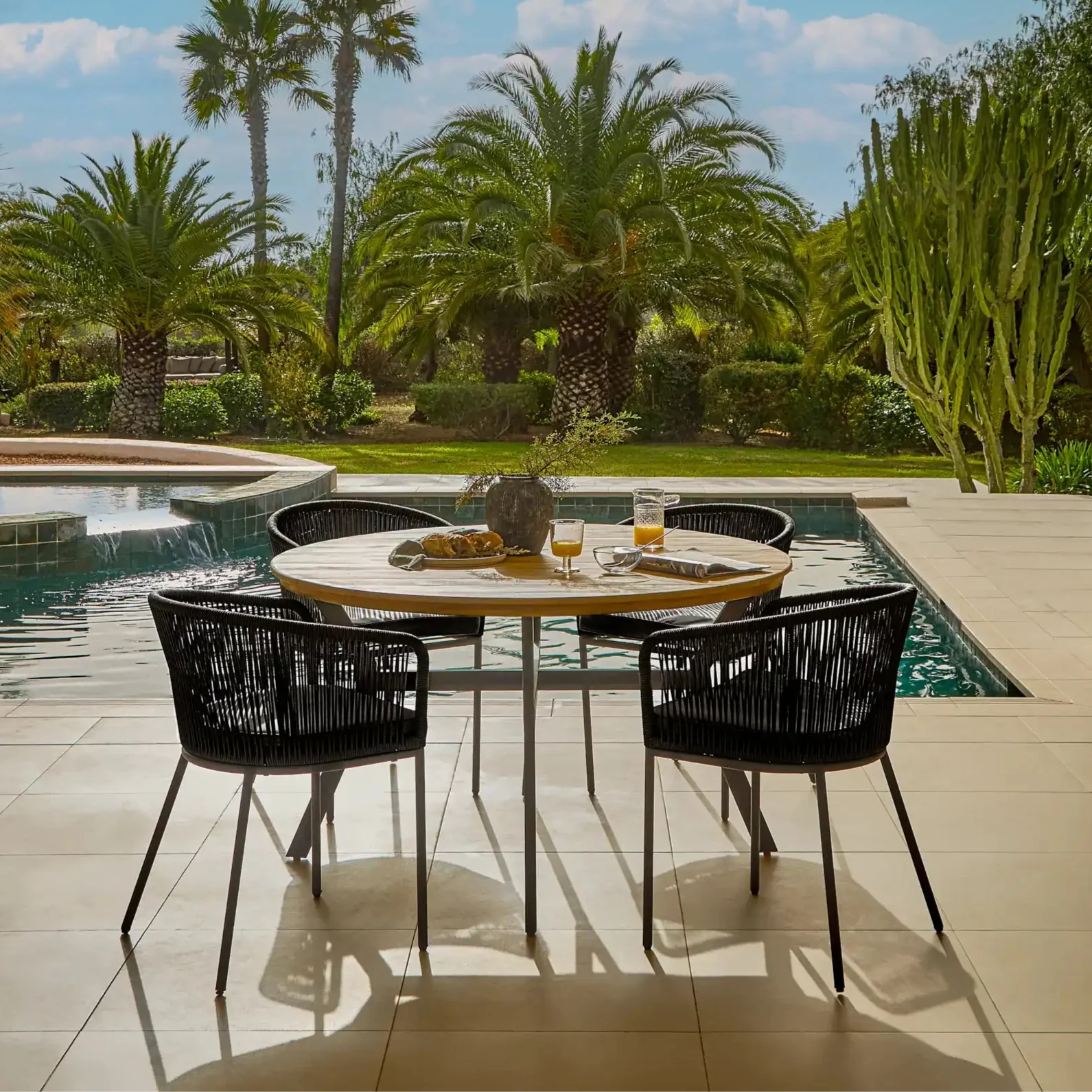 Ezra Whitewash Round Outdoor Dining Table Set with Black  Hali Rope Chairs - Laura James 