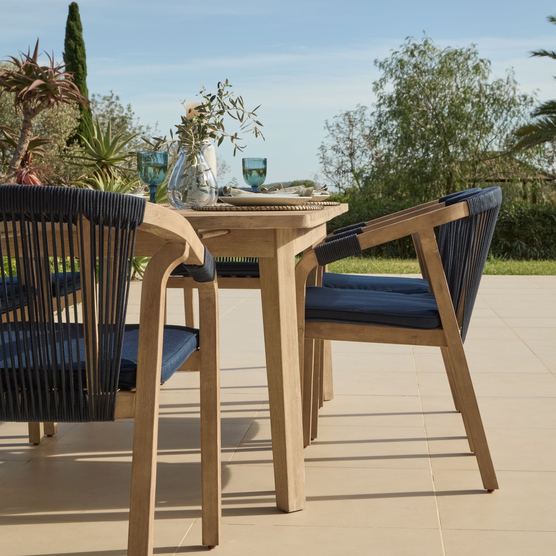 Saffron 6 Seater Extending Wooden Garden Dining Set with Shiro Navy Rope Chairs - Laura James