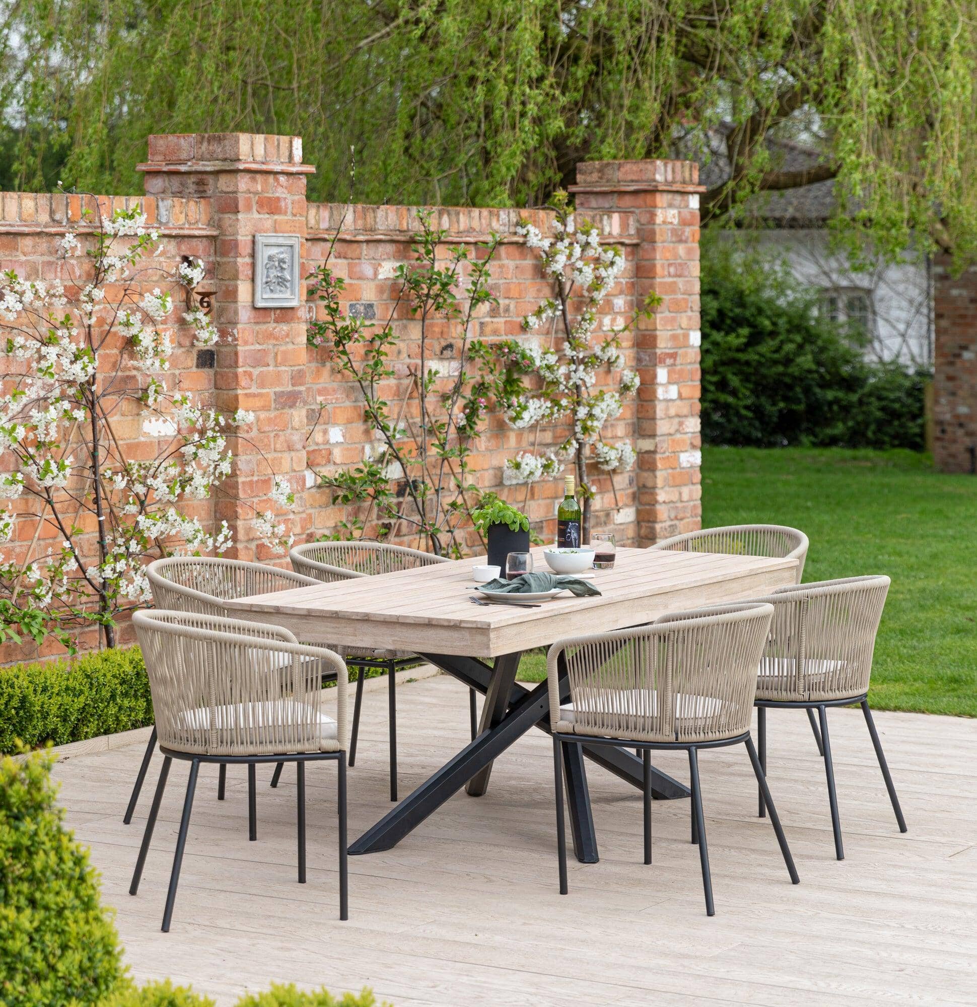 https://laurajamesfurniture.com/cdn/shop/files/amelia-6-seater-whitewash-wood-black-legs-garden-dining-set-hali-natural-chairs-laura-james-1_1940x.jpg?v=1714748954