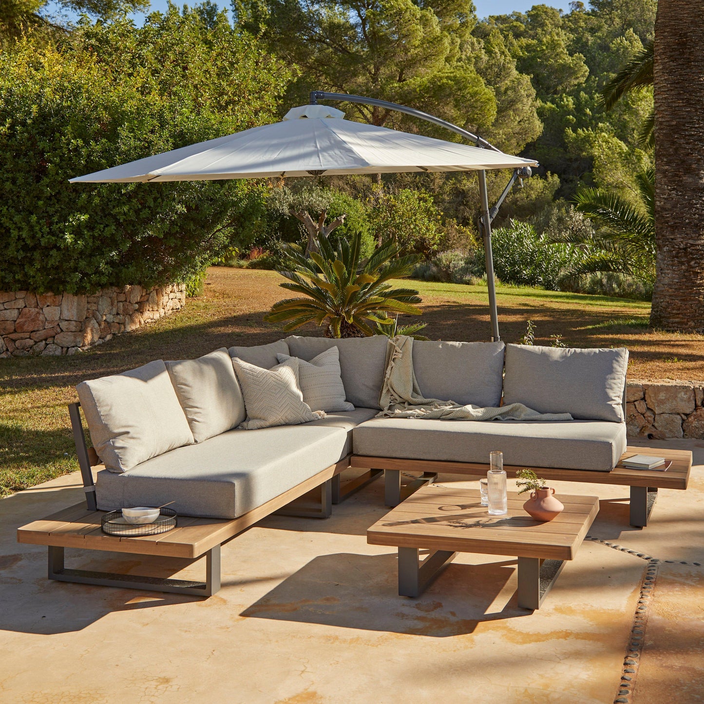 Shiva Stone Garden Corner Sofa Set with Cream Lean Over Parasol - Laura James